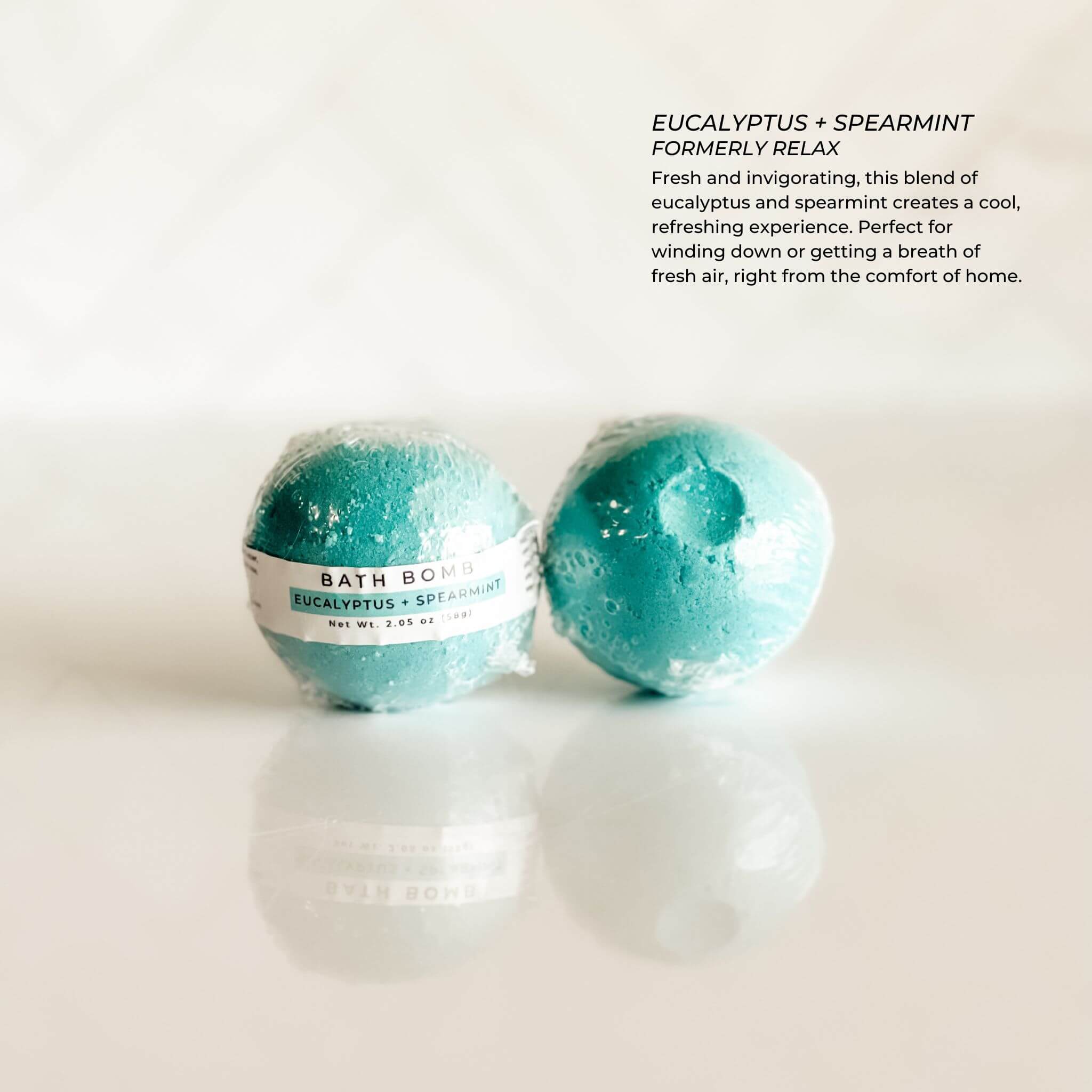Simply Stated Bath & Body Eucalyptus + Spearmint Bath Bomb, individually wrapped in clear packaging. A refreshing blend of eucalyptus and spearmint for a spa-like aromatherapy experience.