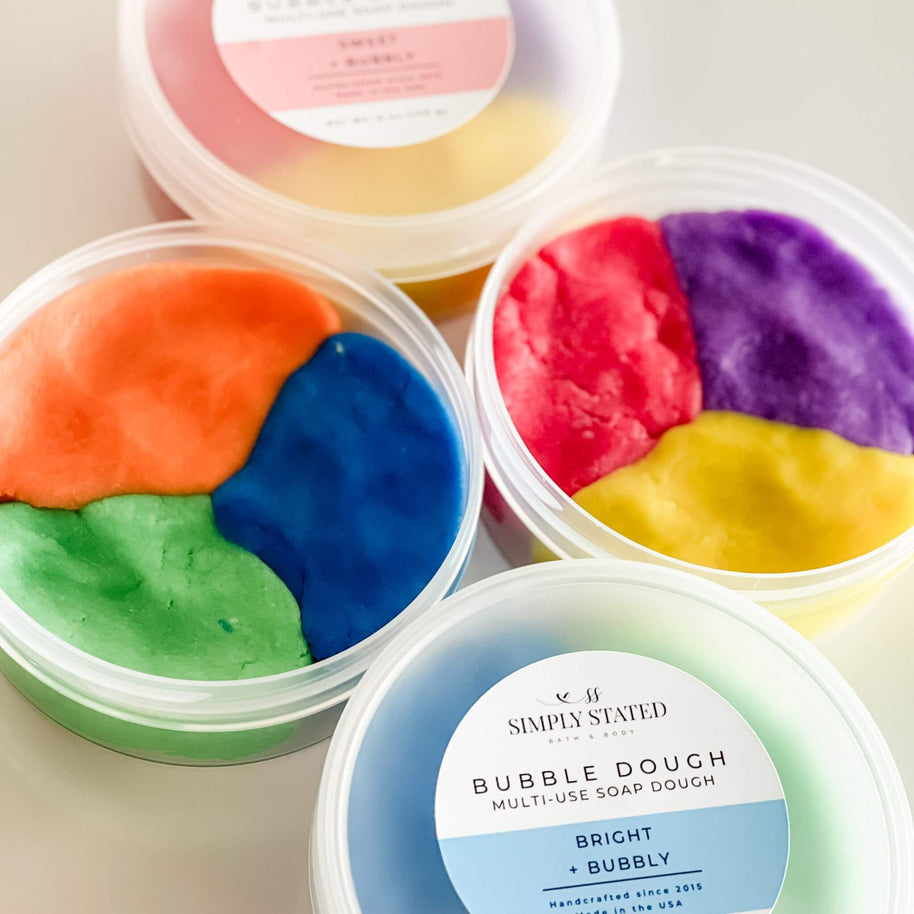Simply Stated Bath & Body Bubble Dough collection featuring vibrant colors and fruity scents. A playful soap dough for molding, washing, and bubbling fun.