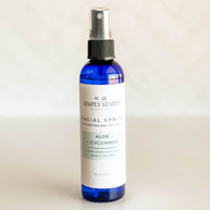 Close-up of Simply Stated Facial Spritz with Aloe + Cucumber, a hydrating mist in a sleek blue bottle, perfect for soothing and refreshing skin.