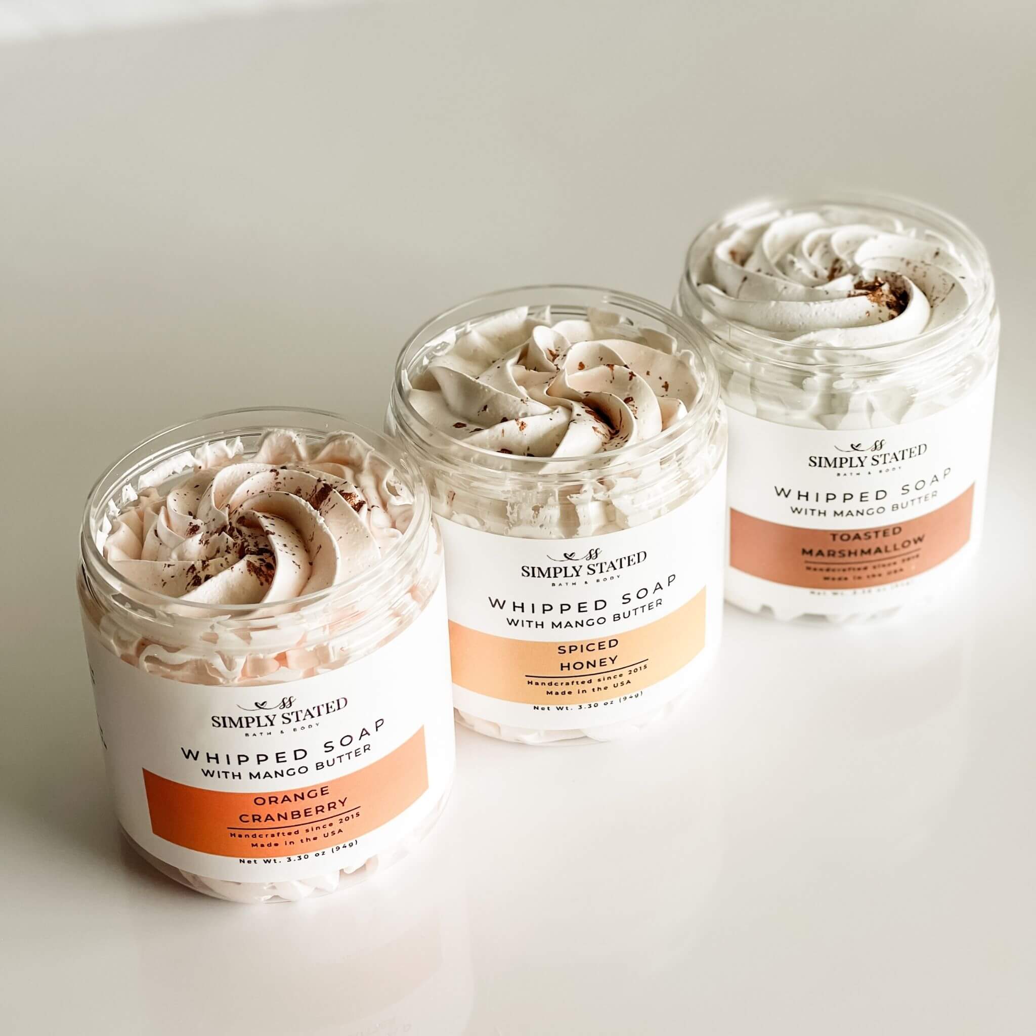 Overhead view of Simply Stated Fall Whipped Soaps in Orange Cranberry, Spiced Honey, and Toasted Marshmallow