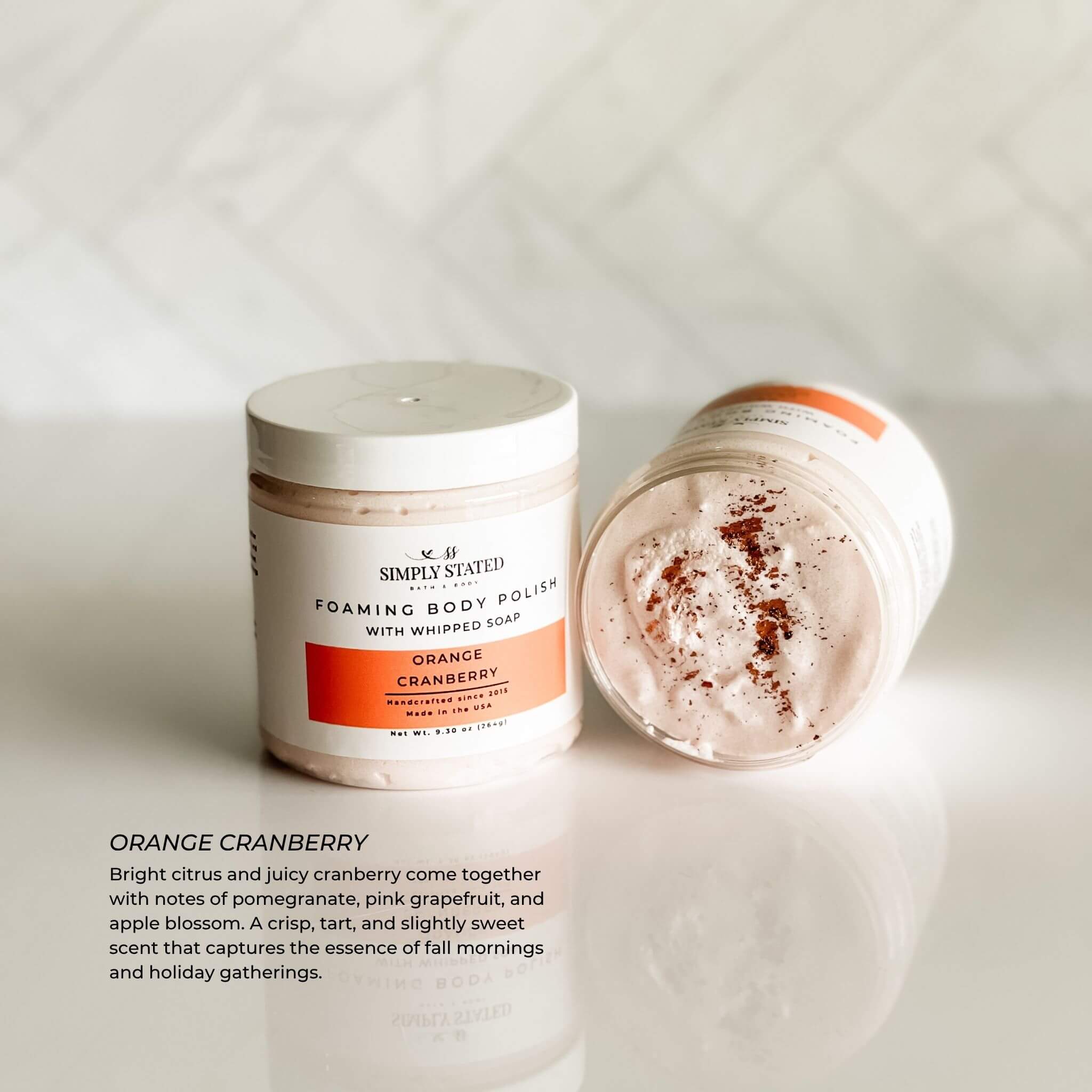 Simply Stated Orange Cranberry Foaming Body Polish with soft pink whipped texture and fall scent description