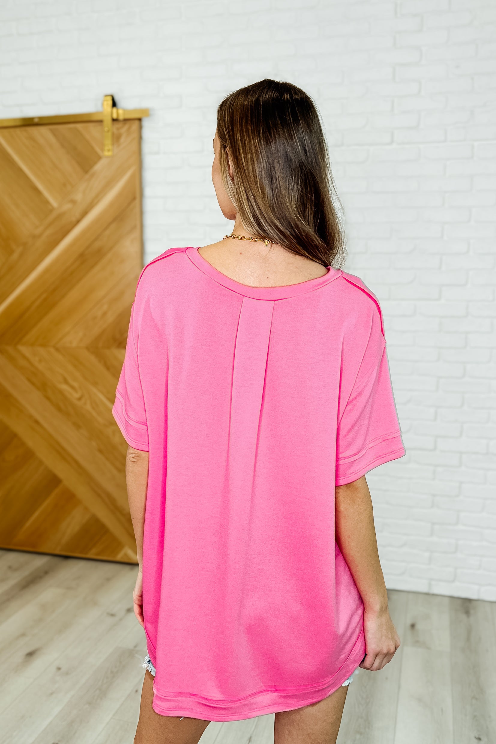 In the Rotation Exposed Seam Tee in Hot Pink