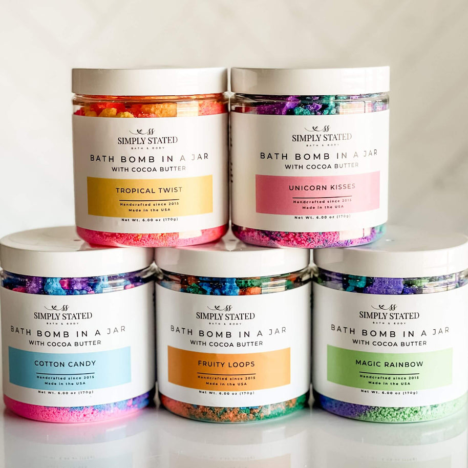 Collection of bath bomb jars with colorful labels on a white background