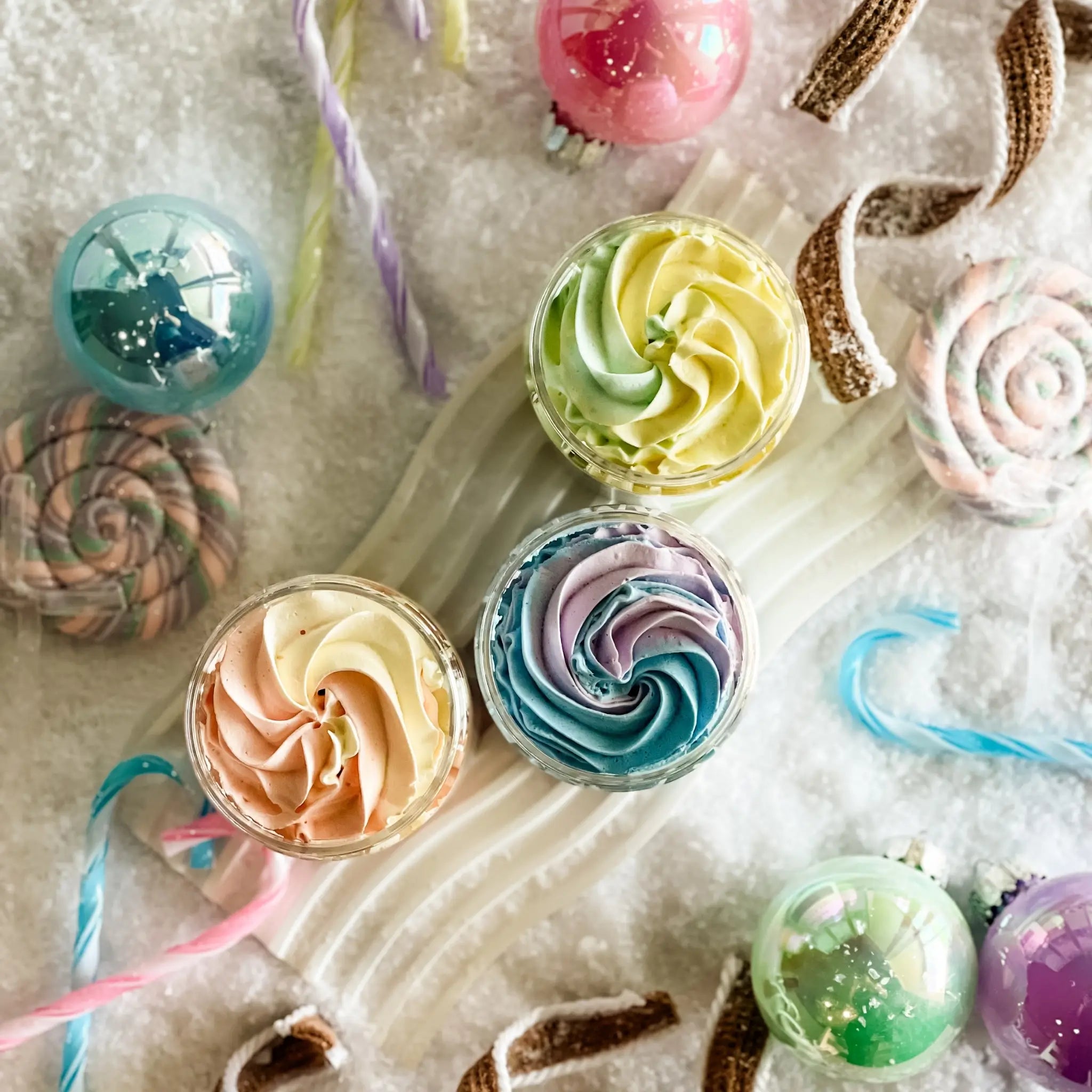 Colorful swirl candies and lollipops on a textured surface