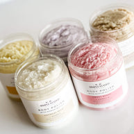 Top-down view of Simply Stated Signature Line Body Polish collection, showcasing creamy and colorful exfoliating scrubs with kokum butter in various scents.