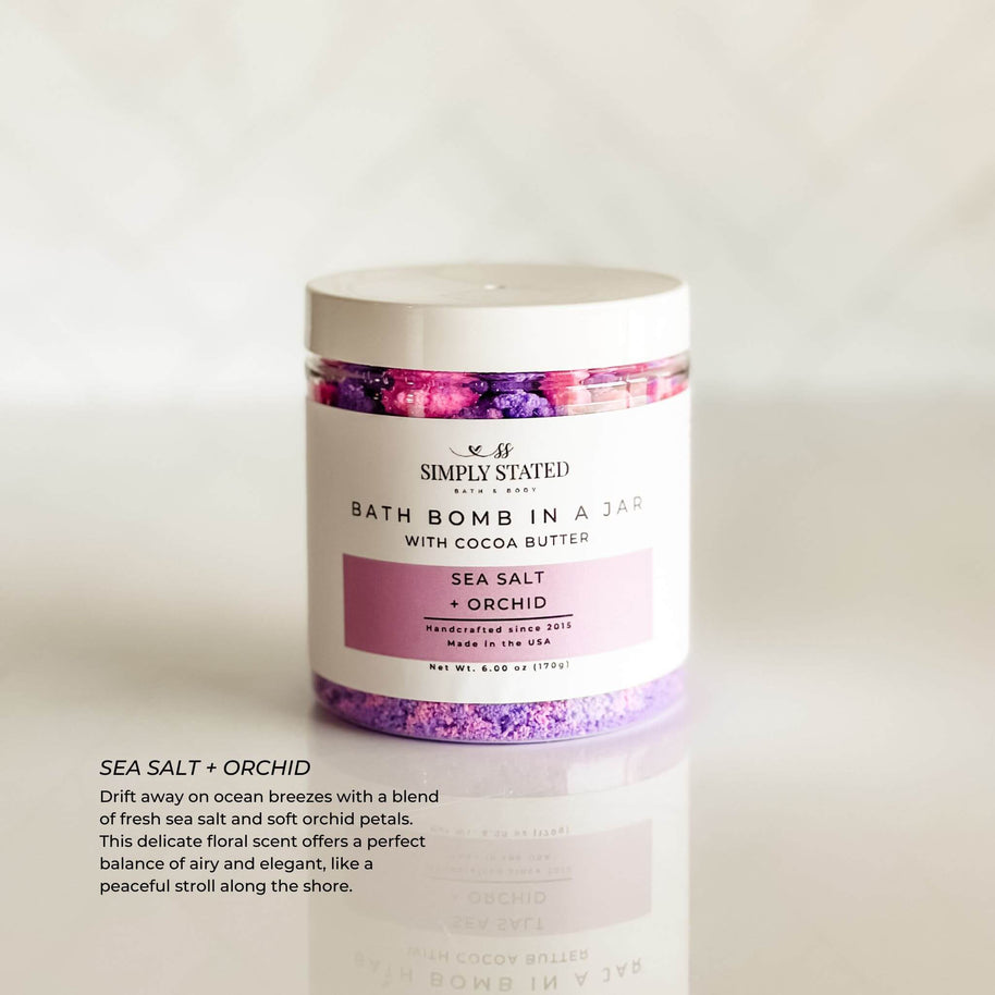 Simply Stated Bath & Body Signature Line Bath Bomb in a Jar - Sea Salt + Orchid. A refreshing mix of sea salt and delicate orchid petals, designed to transform bath time into a spa-like escape with skin-softening ingredients.