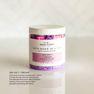 Simply Stated Bath & Body Signature Line Bath Bomb in a Jar - Sea Salt + Orchid. A refreshing mix of sea salt and delicate orchid petals, designed to transform bath time into a spa-like escape with skin-softening ingredients.
