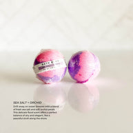 Individually wrapped Sea Salt + Orchid bath bomb from Simply Stated Bath & Body. A refreshing blend of ocean breeze, fresh sea salt, and delicate orchid petals for a coastal-inspired bath.