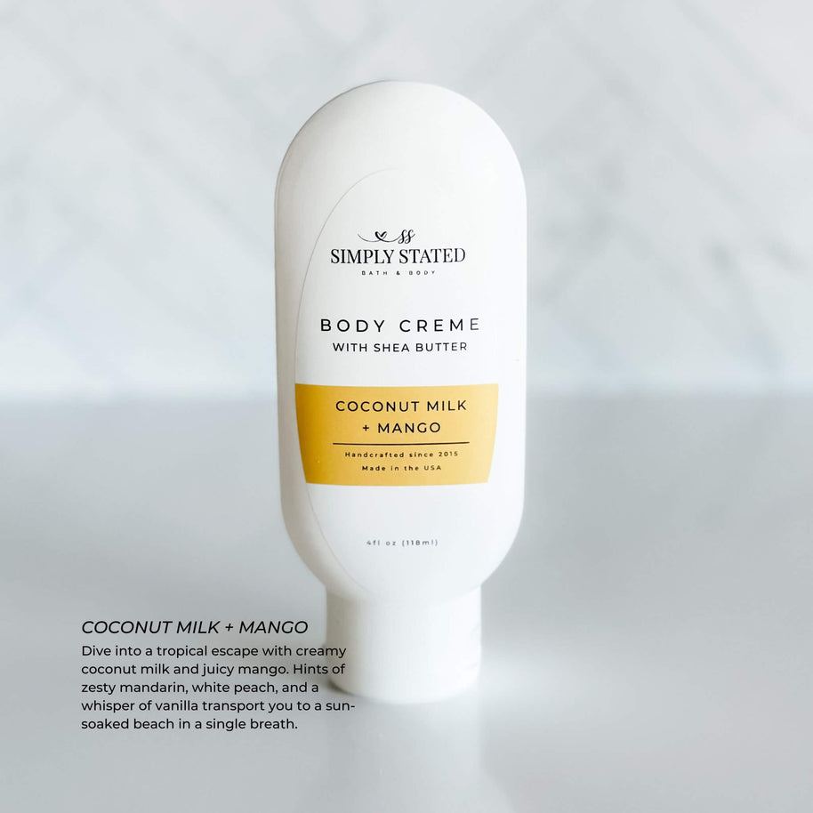 Simply Stated Body Creme in Coconut Milk + Mango scent. A 4oz squeeze bottle enriched with shea butter, offering a tropical blend of creamy coconut milk, juicy mango, and a hint of vanilla. Perfect for moisturizing skin with a sun-soaked beach aroma.