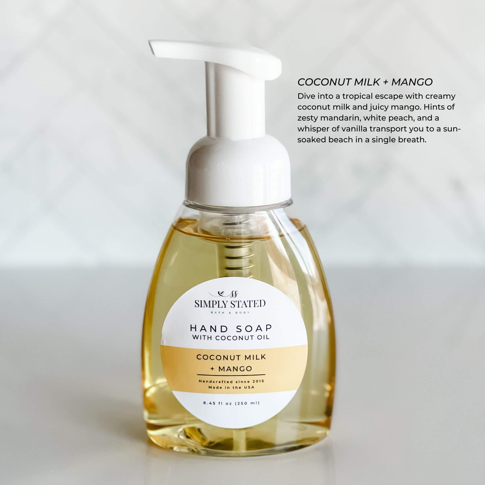 Simply Stated Bath & Body Signature Hand Soap with Coconut Milk + Mango fragrance in an 8oz foaming pump bottle, displayed with a tropical and refreshing scent profile. Perfect for hydrating and cleansing hands naturally.